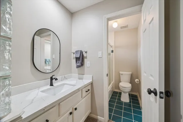 an aerial view of residential houses with outdoor space and trees