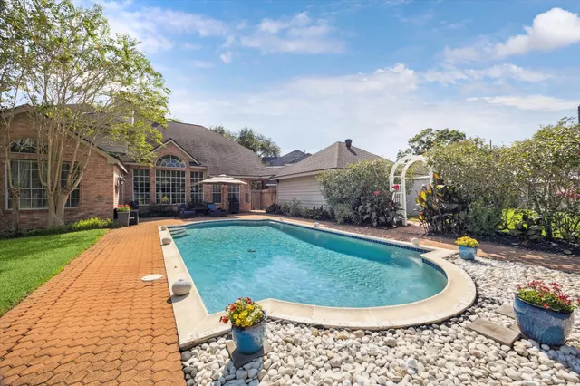 a view of swimming pool with outdoor seating and city view