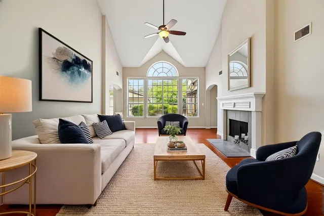 a kitchen with stainless steel appliances granite countertop a refrigerator a sink a stove and white cabinets