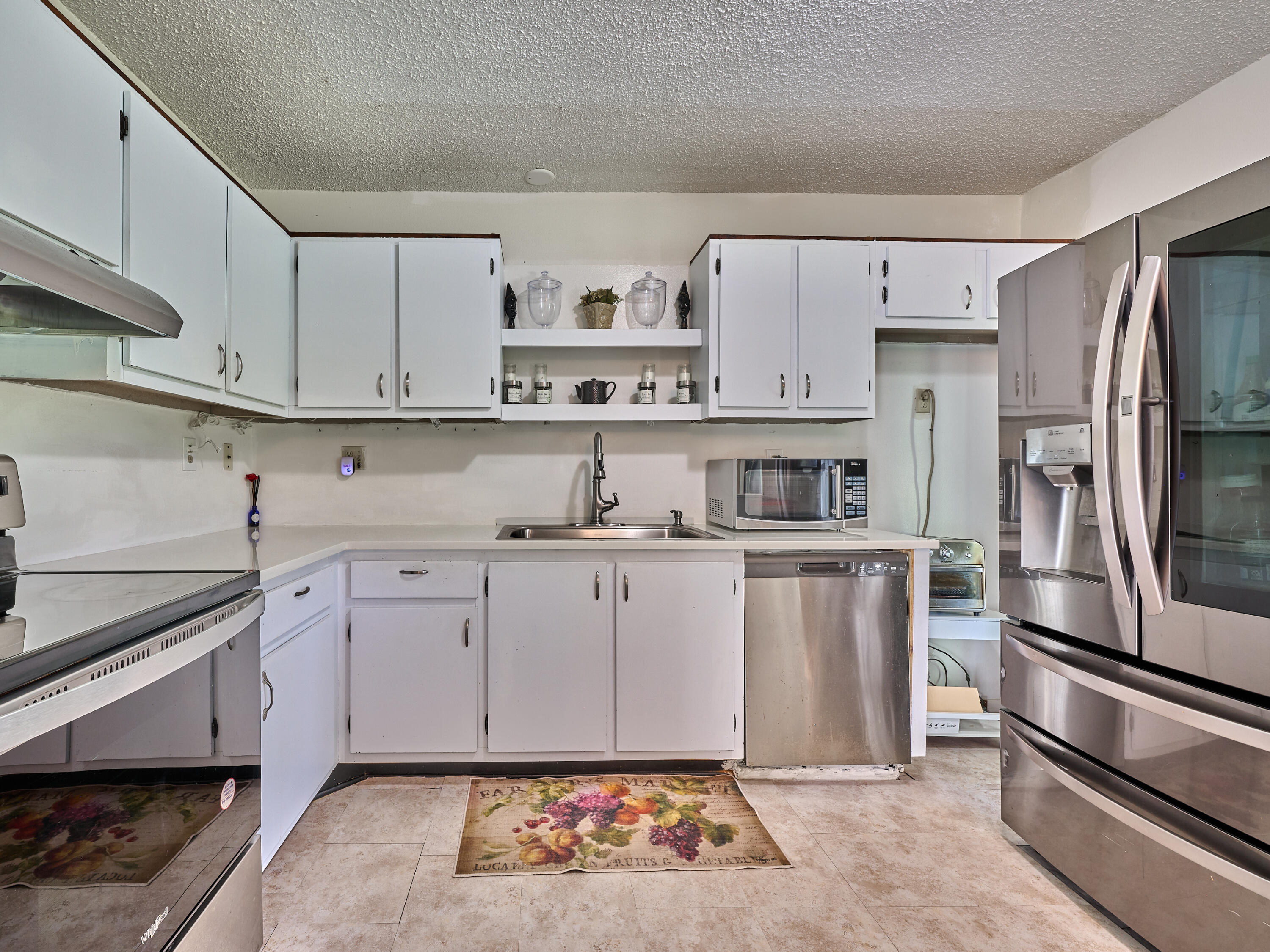 5197 Minto Road Boynton Beach, FL 33472 - Photo 11 of 32 a kitchen with stainless steel appliances granite countertop a refrigerator sink and stove