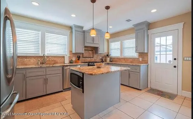 a kitchen with a sink stove and cabinets