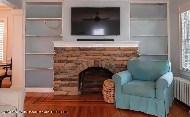 a living room with furniture and a fireplace
