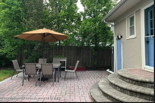a view of a patio with couple of chairs