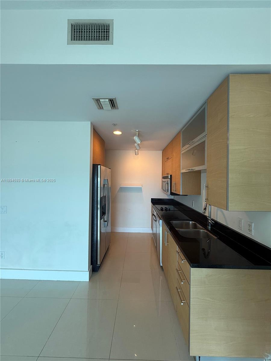 60 Southwest 13th Street, Unit 3809 Miami, FL 33130 - Photo 5 of 6 a kitchen with a sink and a stove
