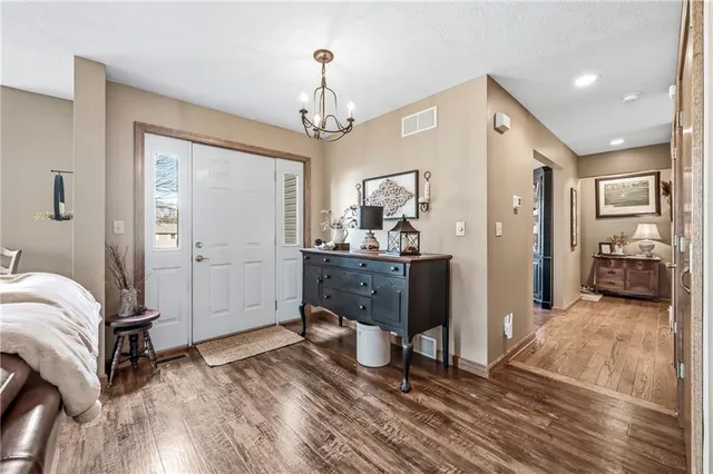 a living room with furniture large window and a table