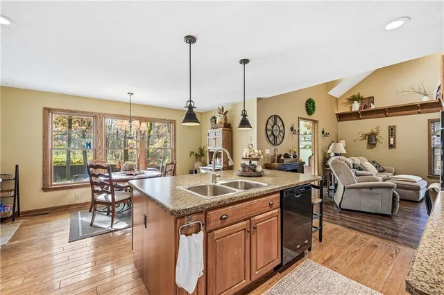 a kitchen with a dining table chairs sink and stove