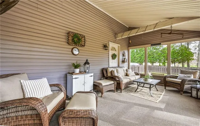 a living room with furniture and floor to ceiling windows