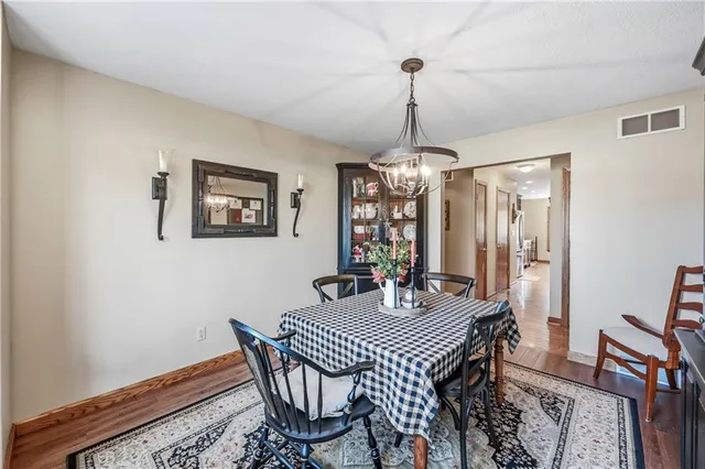 a dining room with furniture a chandelier and window