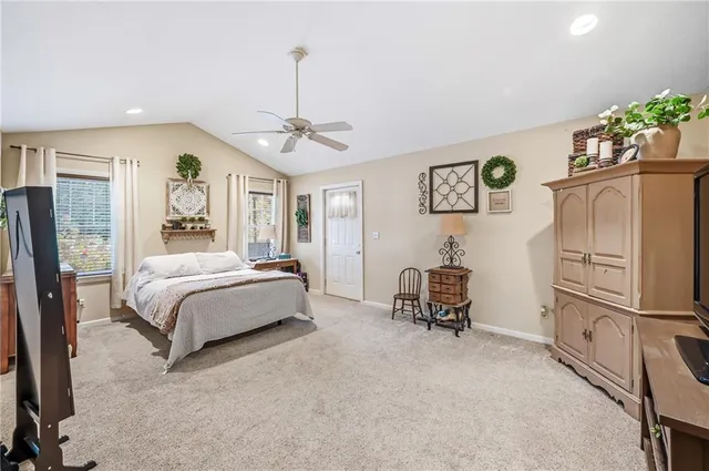 a spacious bedroom with a bed and large window