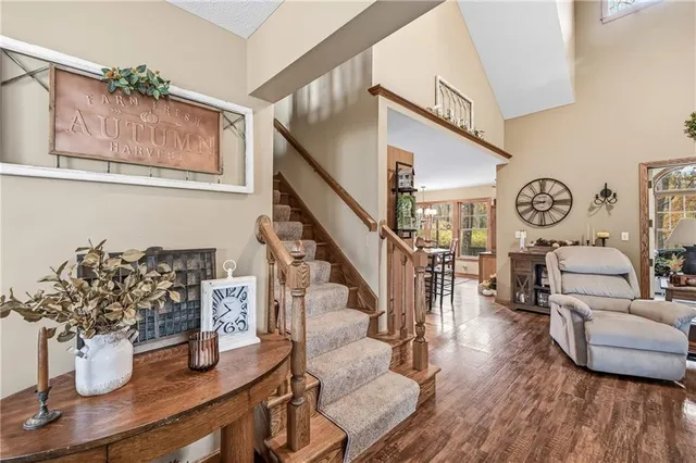 a view of staircase with lots of frames on wall and wooden floor