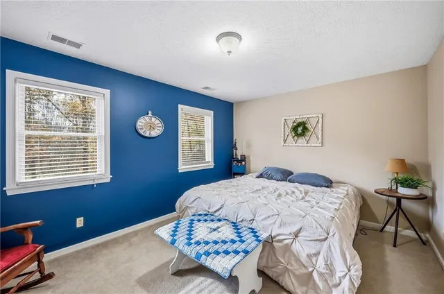 a living room with furniture a flat screen tv and a window
