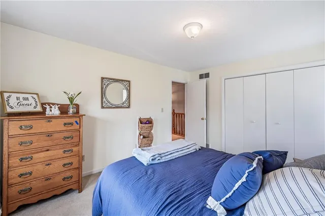 a spacious bedroom with a bed and a couch