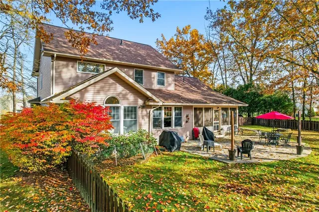 a view of house with swimming pool outdoor seating