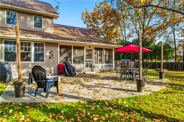 a view of a house with backyard porch and sitting area