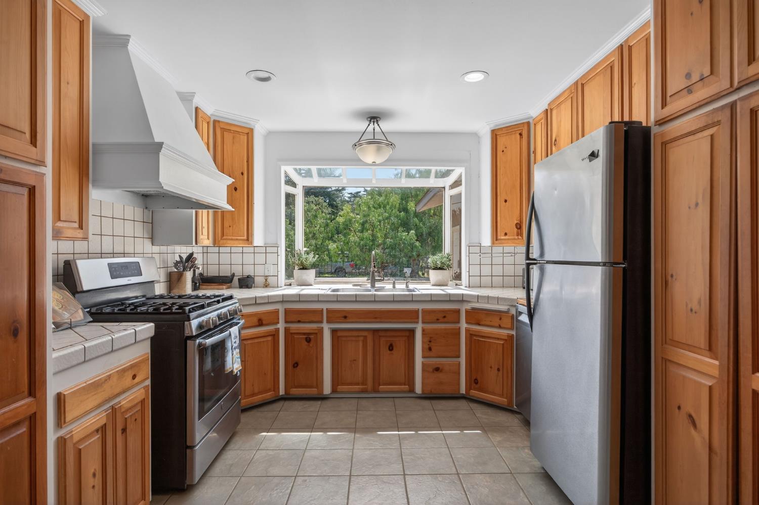 1977 South Rice Road Ojai, CA 93023 - Photo 6 of 27 a kitchen with stainless steel appliances granite countertop a stove a sink and a refrigerator