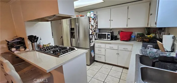 a kitchen with a sink a stove and cabinets