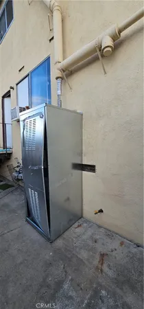 a view of a refrigerator in kitchen and empty room