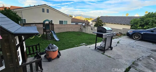 a view of a house with a yard and sitting area