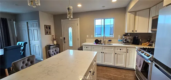 a kitchen with a sink stove and cabinets
