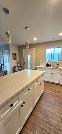 a large kitchen with kitchen island a sink stainless steel appliances and cabinets
