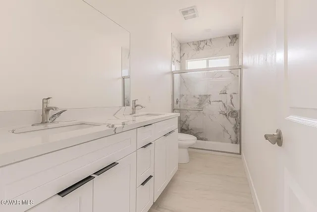 an empty room with a window and a ceiling fan