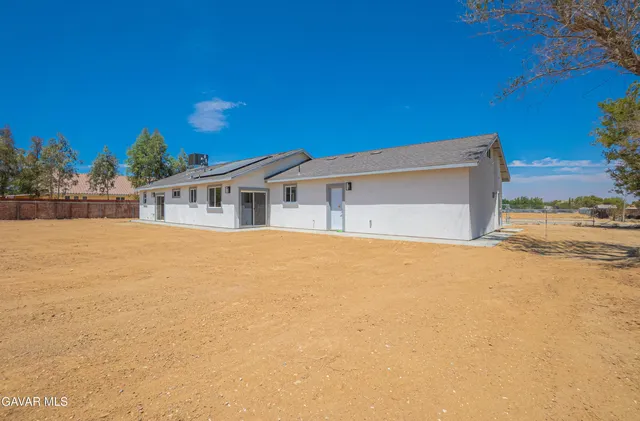 an aerial view of a house with a yard and lake view