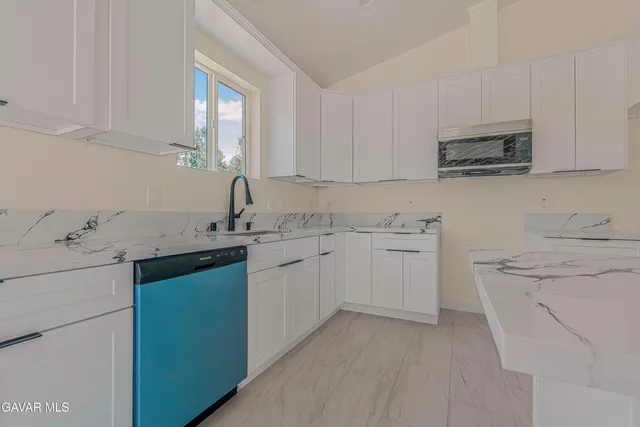 a kitchen with a sink stove and cabinets