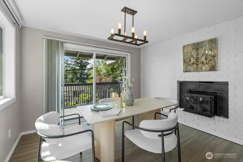 a dining room with furniture a fireplace and a chandelier