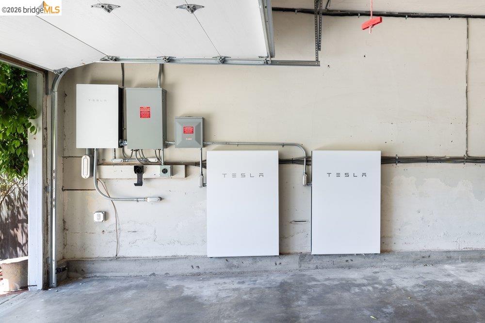 287 Purdue Avenue Kensington, CA 94708 - Photo 56 of 60 Integrated energy storage system with two Tesla Powerwall units and associated electrical components mounted on a neutral-toned wall