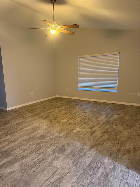 2596 Landover Boulevard Spring Hill, FL 34608 - Photo 5 of 16 a view of empty room with wooden floor and fan