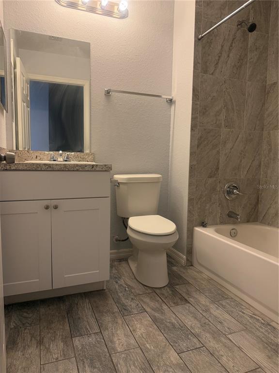 2596 Landover Boulevard Spring Hill, FL 34608 - Photo 8 of 16 a bathroom with a toilet a sink and bathtub