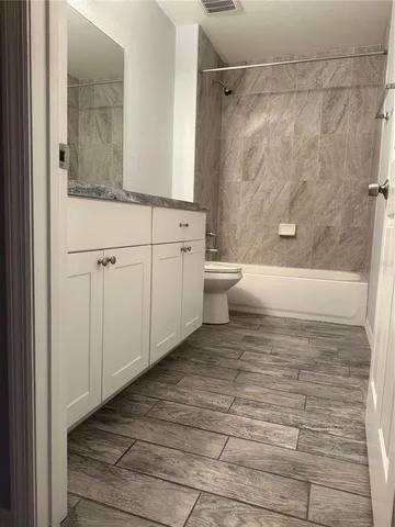 a bathroom with a toilet a sink and shower
