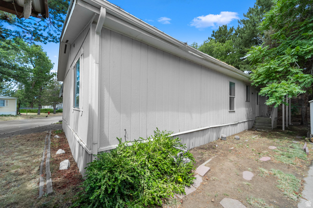 2875 North 400 West, Unit 7 Layton, UT 84041 - Photo 22 of 29 Exterior siding with vertical paneling, white trim, and a white gutter system