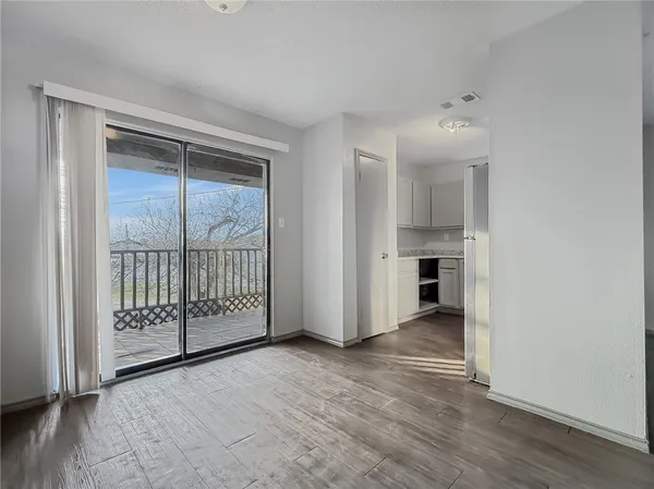 an empty room with windows and entryway