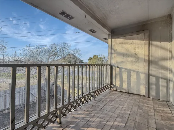 a view of a porch with wooden floor
