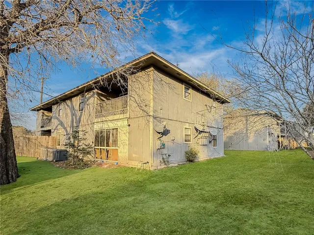 a view of a back yard of the house with green space