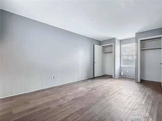 an empty room with closet area