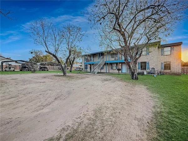 a view of a house with a yard