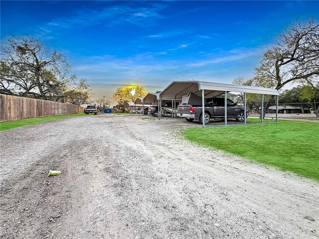 a view of a house with backyard and sitting area