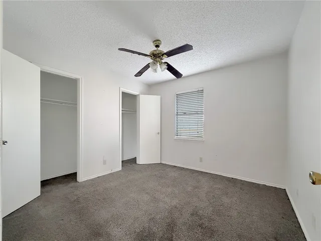 a view of a livingroom with a ceiling fan and window