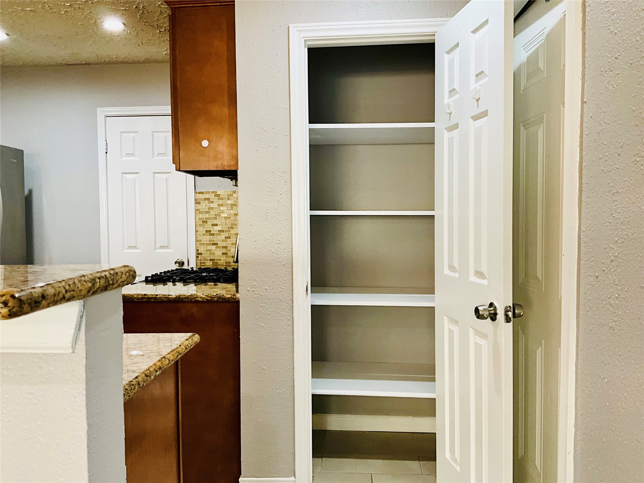 11827 Moss Branch Road Houston, TX 77043 - Photo 15 of 41 a kitchen with a refrigerator and a stove