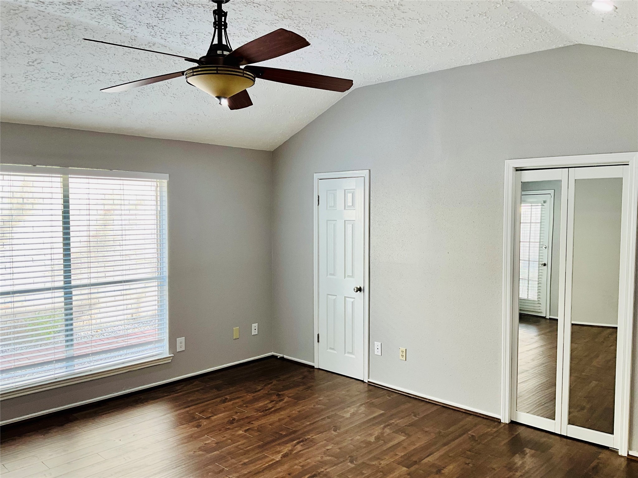11827 Moss Branch Road Houston, TX 77043 - Photo 18 of 41 a view of room with window ceiling fan and hardwood floor