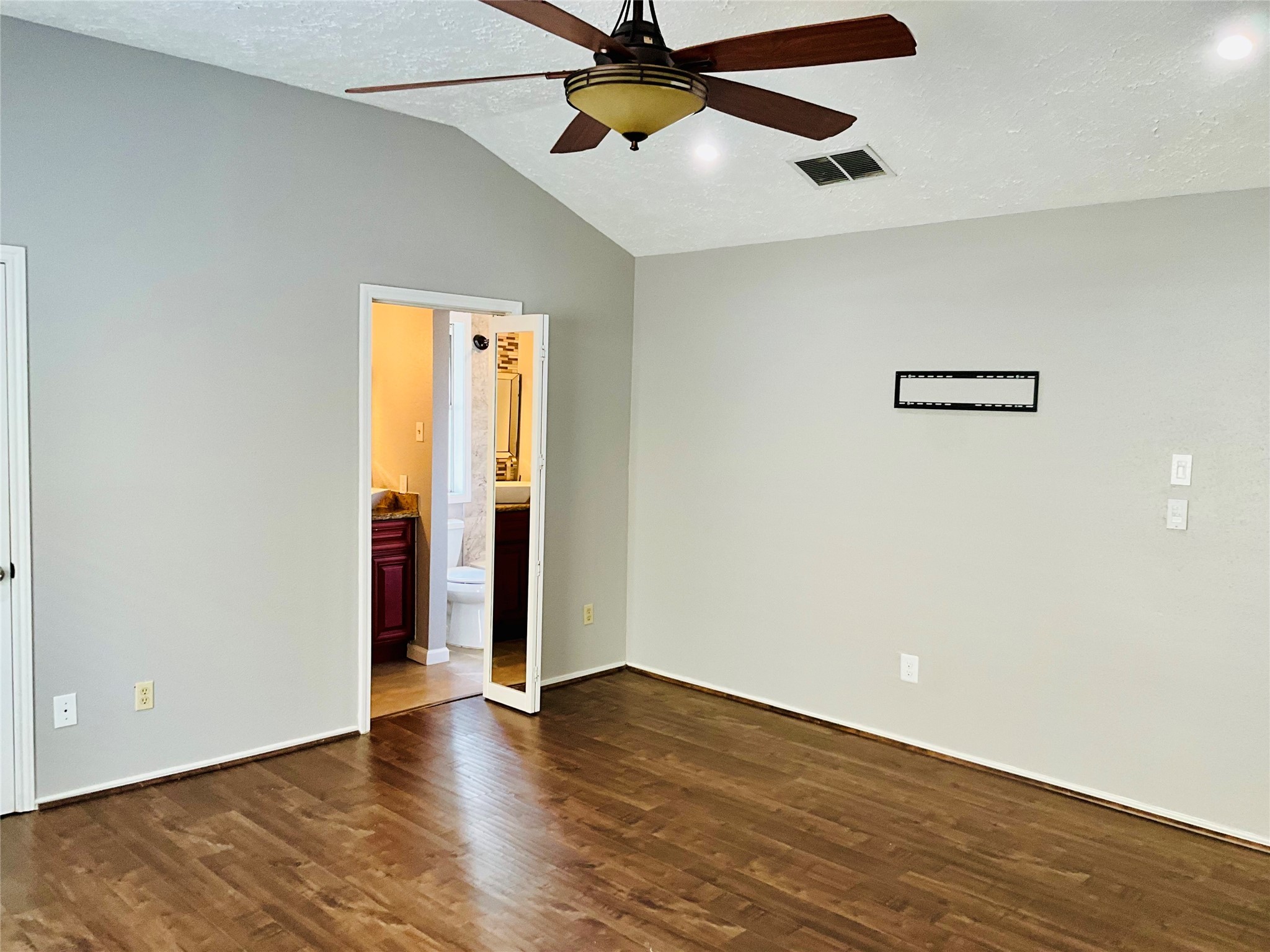 11827 Moss Branch Road Houston, TX 77043 - Photo 19 of 41 an empty room with wooden floor ceiling fan and windows