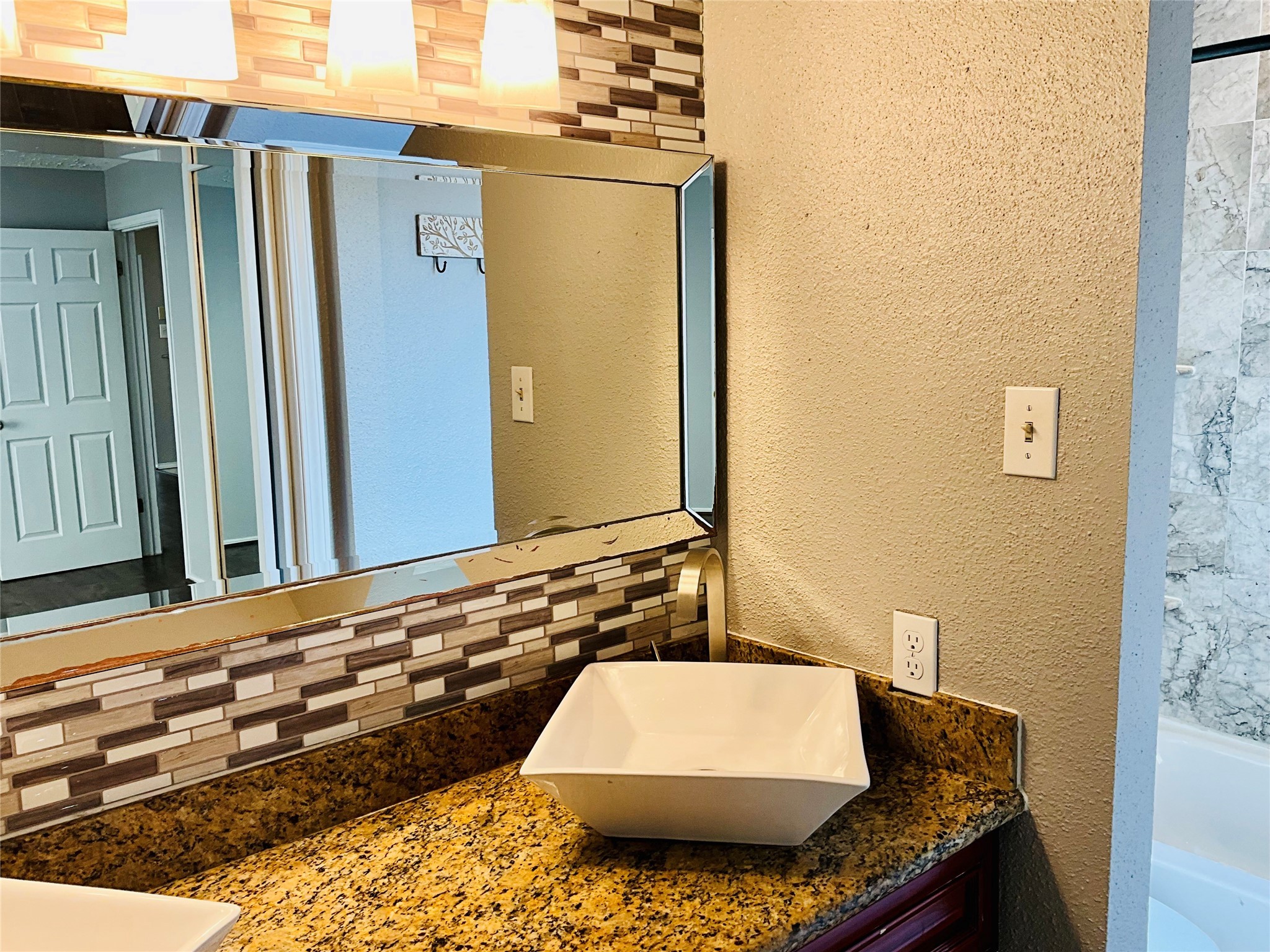 11827 Moss Branch Road Houston, TX 77043 - Photo 20 of 41 a bathroom with a granite countertop sink and a mirror
