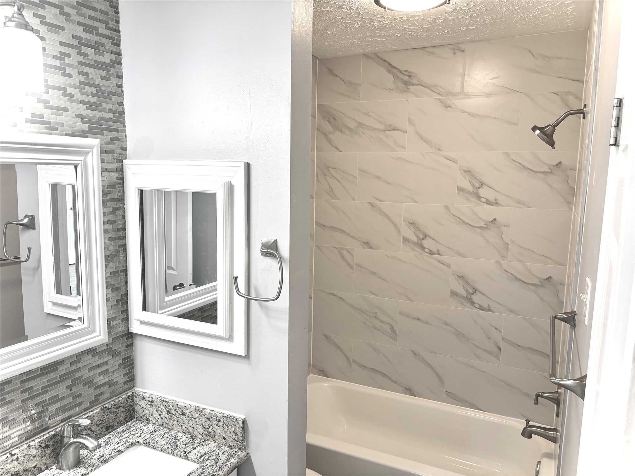 11827 Moss Branch Road Houston, TX 77043 - Photo 22 of 41 a bathroom with a bathtub and shower