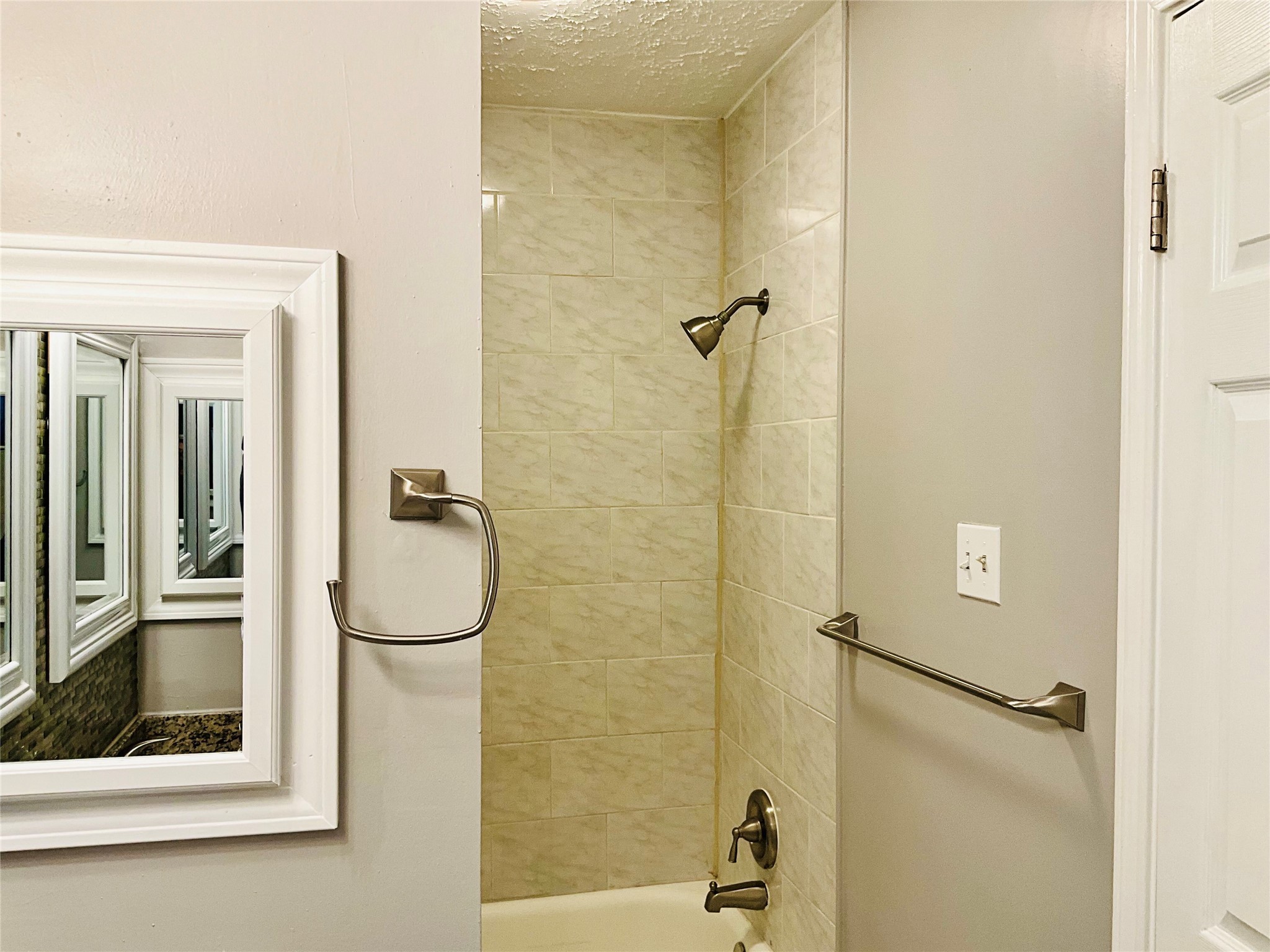 11827 Moss Branch Road Houston, TX 77043 - Photo 26 of 41 a bathroom with a glass shower door