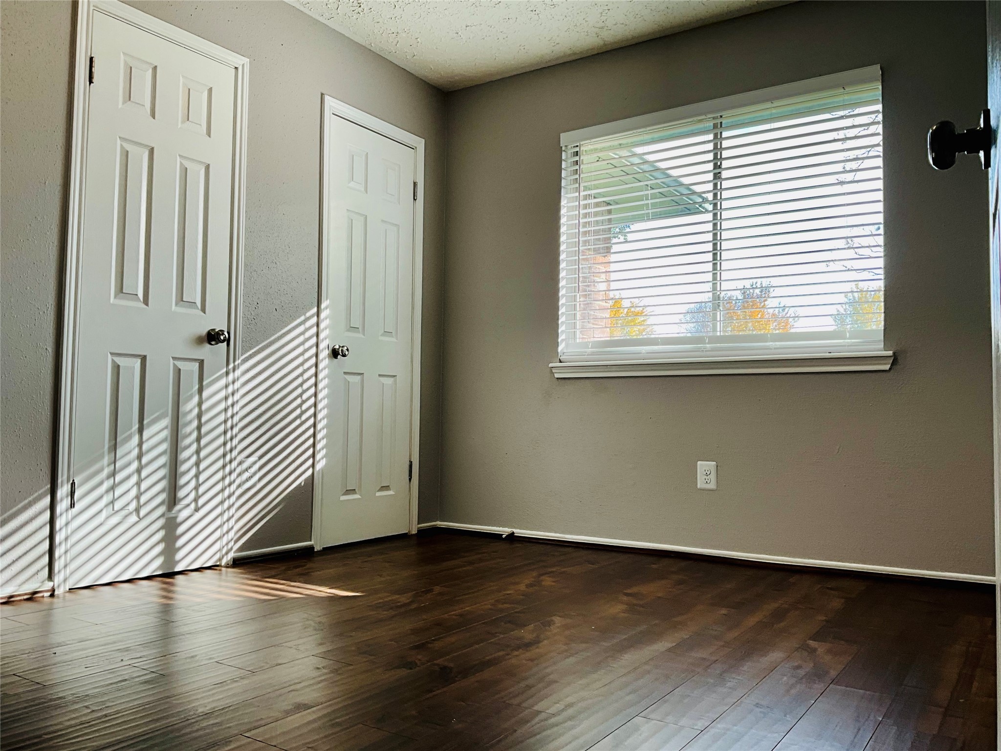 11827 Moss Branch Road Houston, TX 77043 - Photo 27 of 41 an empty room with wooden floor and windows
