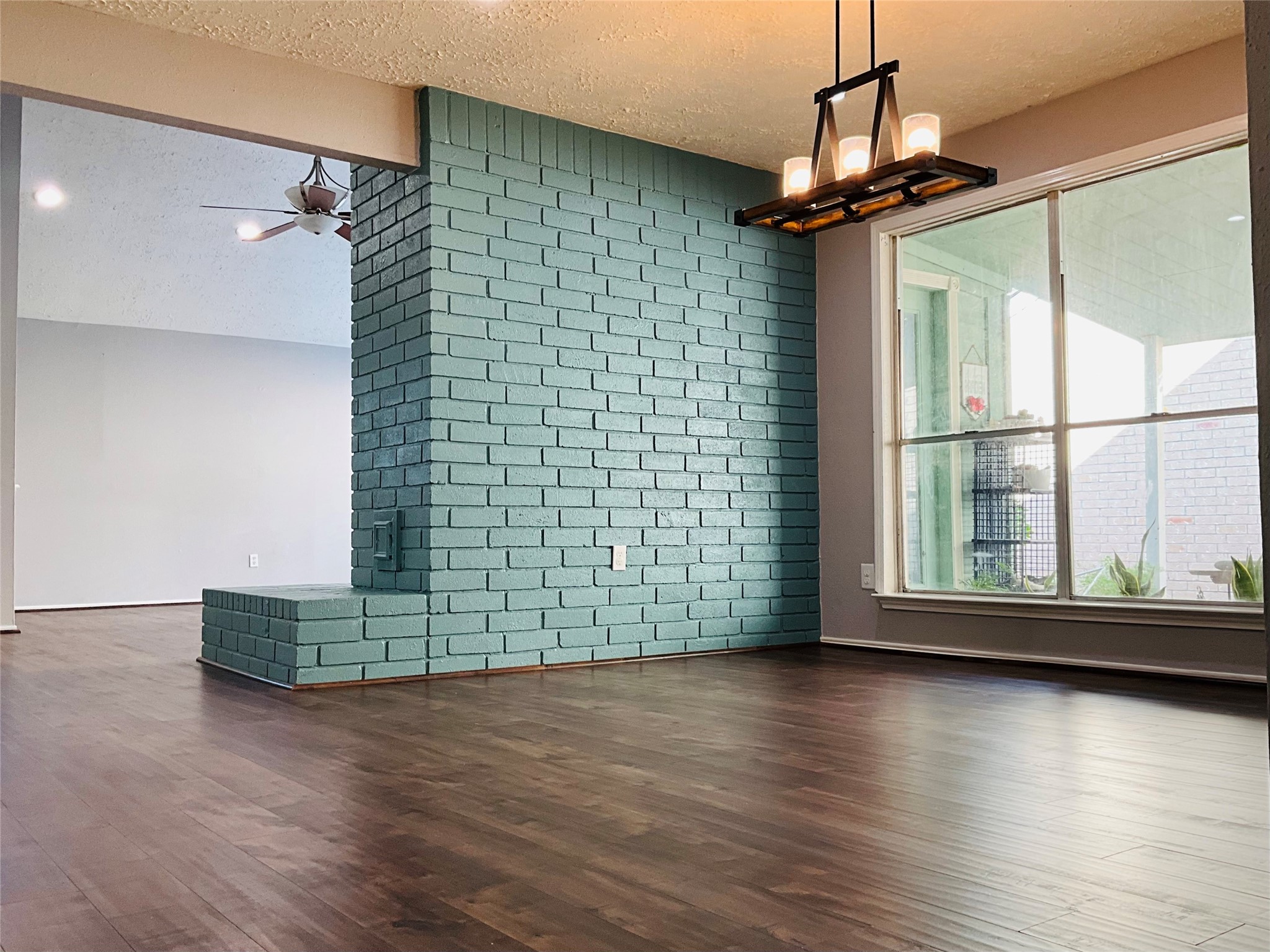 11827 Moss Branch Road Houston, TX 77043 - Photo 9 of 41 a view of a livingroom with wooden floor and a large window