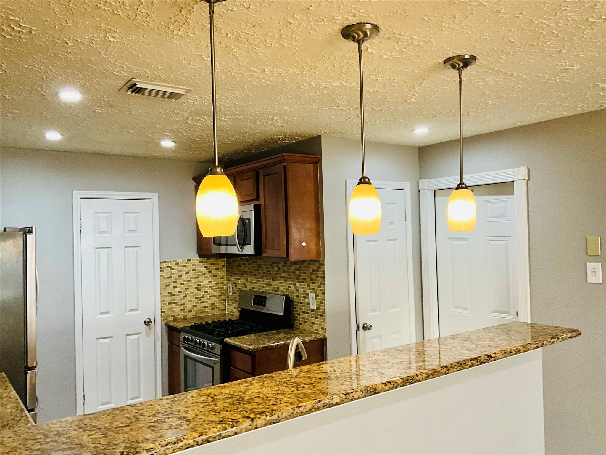 11827 Moss Branch Road Houston, TX 77043 - Photo 10 of 41 a kitchen with a refrigerator a stove and a sink