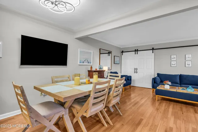 a view of a livingroom with furniture and a flat screen tv